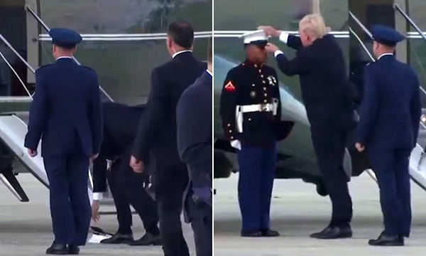 風に飛ばされた若い黒人の海兵隊員の帽子を追いかけて屈んで拾ってかぶせてあげるトランプ大統領